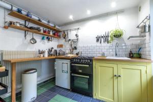 a kitchen with a stove and a sink at Chez Miriam - Maison de caractère - Ville avec jardin in Montrichard