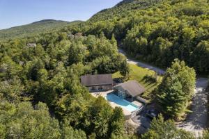 an aerial view of a house in the woods at New host! Exceptional Sunday River Ski In Ski Out Condo in Newry