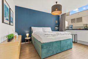 a blue bedroom with a bed and a blue wall at LAM Yacht Club w AC & Terrace in Bratislava