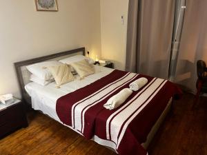 a bedroom with a bed with two towels on it at Xanthis Hostel Nicosia City Centre in Nicosia