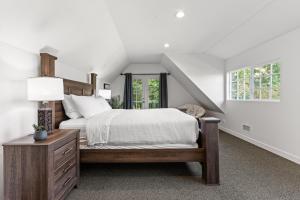 a white bedroom with a bed and a window at Private Mountainside Home in Chilliwack