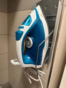 a blue and white hair dryer hanging on a wall at Apartmán ERUDITO in Jihlava