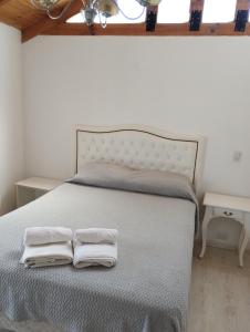a bedroom with a bed with two towels on it at Departamento Puerto Madryn! Patagonia Beach in Puerto Madryn
