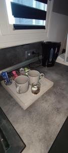 a cutting board with three cups and bowls on it at Se reposer à p'tit Ebé in Macheren +12 photos