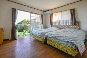 Postel nebo postele na pokoji v ubytování Atami SANKAITEN with Private ONSEN-vacation rental