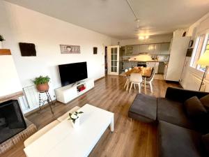 a living room with a couch and a table at CASA PARAÍSO PISCINA TRANQUILIDAD in Sant Cebrià de Vallalta