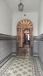 an entrance to a room with a gate and a tile floor at Una casa azul en el sur in Manzanilla