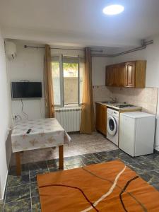 a kitchen with a table and a stove and a microwave at Apartments Mušović in Bar