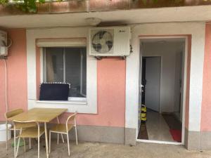 a table and chairs in front of a house at Apartments Mušović in Bar