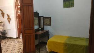 a bedroom with a bed and a dresser next to a table at Una casa azul en el sur in Manzanilla