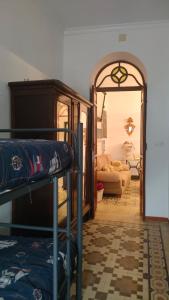a room with a bunk bed and a living room at Una casa azul en el sur in Manzanilla