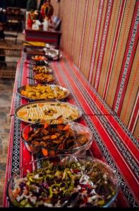 een buffet lijn met veel verschillende gerechten bij Azeez Wadi rum in Disah