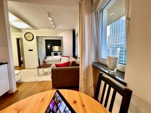 a living room with a couch and a table at FORUM 3 metro fast WiFi 400 Mbs TV HBO Disney+ in Warsaw