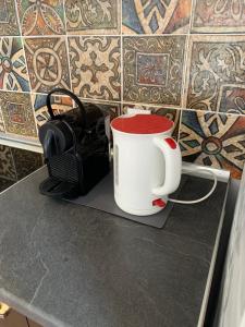 a coffee cup sitting on top of a counter at La Bandolaise à Perdika in Perdika