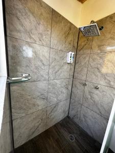 a shower with a glass door in a bathroom at CASA MARIN MANDIMBO in Oaxaca City