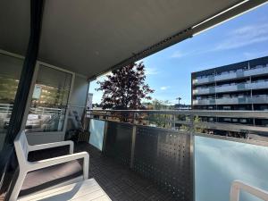 a balcony with a chair and a building at Tøyen T-bane station in Oslo