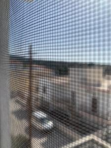 a view of an airport through a barred window at La Bandolaise à Perdika in Perdika