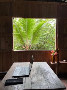 a laptop sitting on a wooden table in front of a window at Perla del cabo in Arusí