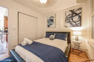 a bedroom with a large bed with blue pillows at Pilsen Paradise l 3 miles to DT in Chicago