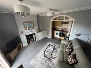 a living room with a couch and a fireplace at The Ingleside Apartment in Basingstoke
