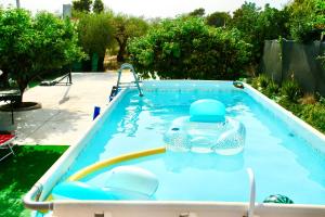 a swimming pool with a toy in the water at Una Vita In Vacanza in Comiso