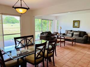 a living room with a glass table and chairs at 3BR/3.5BA Golf & Beach Villa in Río Hato