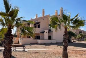 two palm trees in front of a building at Casa Rust en Ruimte in Murcia