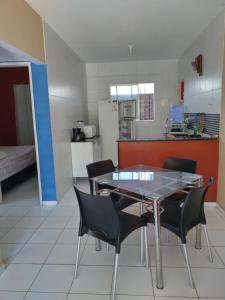 a kitchen with a table and chairs in a room at Casa de praia para temporada in Paulista