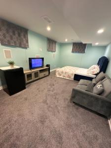 倫敦的住宿－Aiden Mansion，一间带沙发、电视和床的卧室