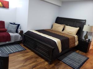 a bedroom with a large bed and a couch at Luxurious 1BR - 1BA Apt Modern Bright with free parking in Brampton