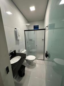 a bathroom with a toilet and a sink and a shower at Honório Pousada-Caldas do Jorro BA in Tucano