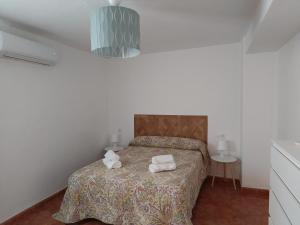 a bedroom with a bed with two towels on it at San Acacio 22 in Ronda