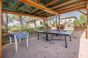 two ping pong tables sitting under a pavilion at Anilde, house with private pool, Colle di Val d'Elsa, Toscana in Colle di Val d'Elsa