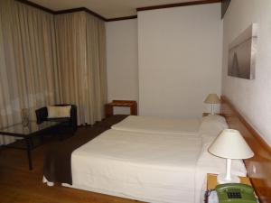 Postel nebo postele na pokoji v ubytování Hotel Windsor