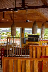 a restaurant with a table and chairs and windows at Golden Hill Parker Hotel in Elmina