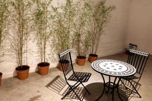 two chairs and a table and some potted plants at Palermo Apartment in Buenos Aires