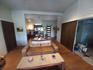 a living room with a couch and a table at Casa Pucon sector Laguna ancapulli in Pucón +44 photos
