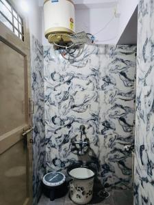 a bathroom with a blue and white wallpaper with a sink at Citylight Family Homestay in Mysore