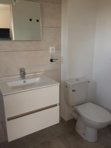 a bathroom with a white toilet and a sink at nature in Gardanne