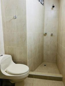 a bathroom with a toilet and a shower at Apartamento Santa marta el rodadero in Gaira