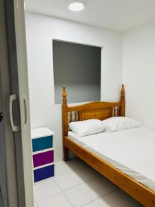 a bedroom with a wooden bed with white pillows at Apartamento Santa marta el rodadero in Gaira