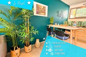 a dining room with plants and a table with a blue wall at *Le Royal*Havre De Paix*Wifi* in Marseille