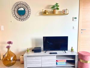 a living room with a tv on a white entertainment center at *Le Royal*Havre De Paix*Wifi* in Marseille