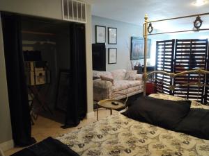 a living room with a bed and a couch at Black Star Ranch Vineyard in Pahrump