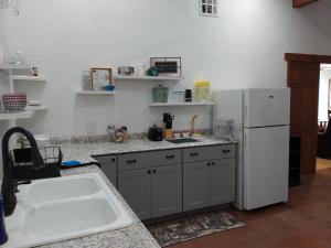 a kitchen with a white refrigerator and a sink at Black Star Ranch Vineyard in Pahrump