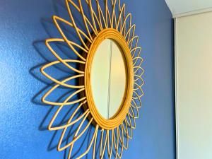 a gold mirror on a blue wall at *Le Royal*Havre De Paix*Wifi* in Marseille