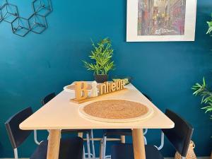 a dining room table with a wooden sign on it at *Le Royal*Havre De Paix*Wifi* in Marseille