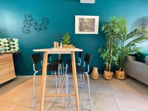 a table and chairs in a room with plants at *Le Royal*Havre De Paix*Wifi* in Marseille