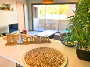 a kitchen counter with a table with a b sign and plants at *Le Royal*Havre De Paix*Wifi* in Marseille