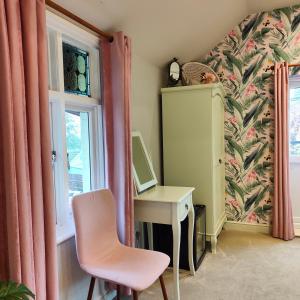 ローストフトにあるThe Corner Houseの窓付きの客室で、デスクと椅子が備わります。